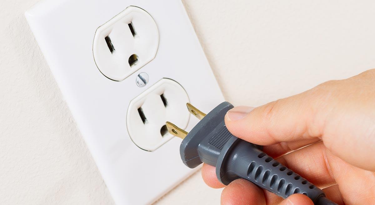 Photo of plugging unit into standard wall outlet Photo of plugging unit into standard wall outlet