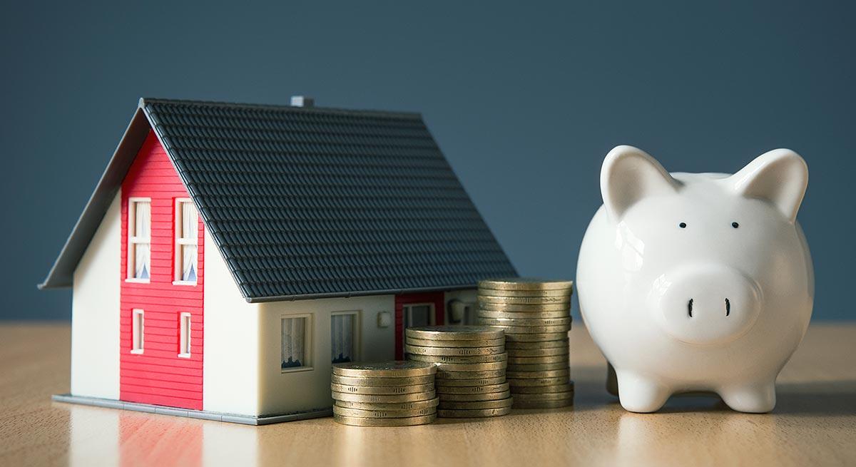 Photo of house and piggy bank showing money savings Photo of house and piggy bank showing money savings